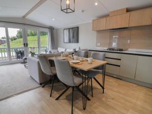 a kitchen and dining room with a table and chairs at The Pines 2 Bedrooms in Northwich +64 photos