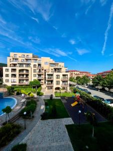 an apartment complex with a playground in a park at Sorrento Pool View Apartment in Sveti Vlas