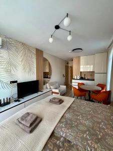 a living room with a large bed and a kitchen at Sorrento Pool View Apartment in Sveti Vlas