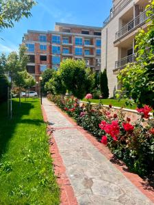 a walkway in front of a building with flowers at Sorrento Pool View Apartment in Sveti Vlas