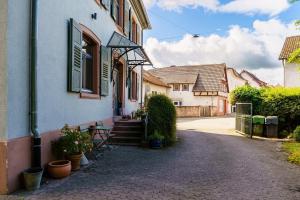 a building with a porch and stairs to a house at Pfarrgarten in Kippenheim