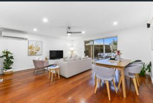 a living room with a couch and a table and chairs at Seffa 5 vella property in Springvale South