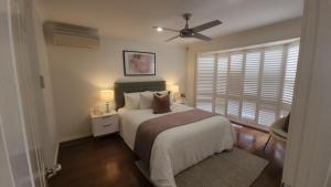 a bedroom with a bed and a ceiling fan at Seffa 5 vella property in Springvale South