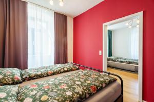 a bedroom with red walls and a bed and a mirror at Pfarrgarten in Kippenheim