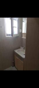 a bathroom with a sink and two windows at Nensi1 in Križišće