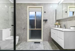 a bathroom with a shower and a toilet and a sink at Seffa 5 vella property in Springvale South +41 photos