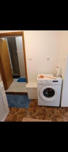 a washing machine in a bathroom with a mirror at Nensi1 in Križišće
