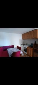 a kitchen with a bed and a table and chairs at Nensi1 in Križišće +8 photos
