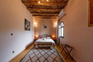 a bedroom with a bed and a rug in a room at La Vida Surf - Yoga Villa in Ounara +36 photos