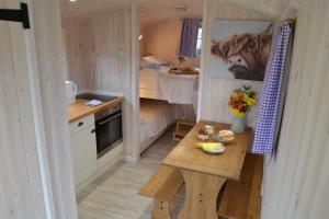 a small kitchen with a table in a tiny house at 2 - Daisy in Woodbridge