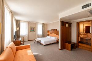 a hotel room with a bed and a couch at Phi Hotel Astoria in Susegana +63 photos