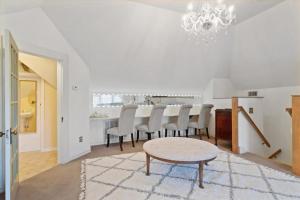 a white dining room with a table and chairs at Four Winds Victorian Venue & Suites in Bonham