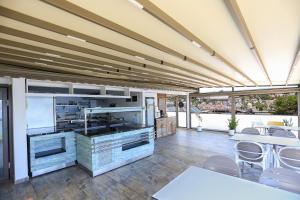 a large room with a kitchen with tables and chairs at Payam Agora Hotel Room Only , Shared Terrace & Kitchen in Kaş