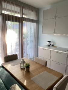 a kitchen with a wooden table and a dining room at SeaSand in Jūrmala +17 photos