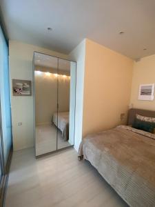 a bedroom with a mirrored closet and a bed at SeaSand in Jūrmala