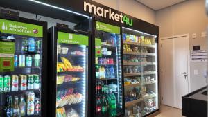 two refrigerators in a store with food and drinks at Ip Alto do Ipiranga by Xtay - Estúdio novo com cozinha e a 1 quadra da estação Alto do Ipiranga in São Paulo