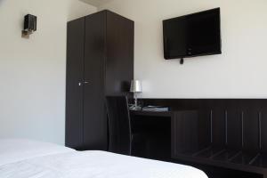 Postel nebo postele na pokoji v ubytování Hotel Ambassadeur