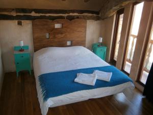 a bedroom with a bed with two pillows on it at Alojamientos Manzanela in Nela