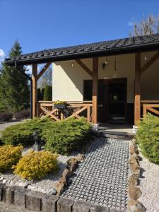 a pavilion with a table in front of a building at Leśny Dwór Bieszczady in Ustrzyki Dolne