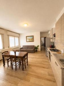 a kitchen and living room with a table and a couch at borgo nel vigneto 2 in Erbusco