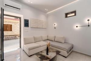 a living room with a couch and a table at The Luxe Residence in episkopi-chania