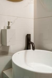 a sink with a faucet in a bathroom at The Luxe Residence in episkopi-chania