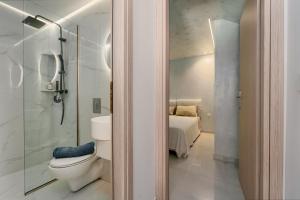 a bathroom with a toilet and a walk in shower at The Luxe Residence in episkopi-chania +7 photos