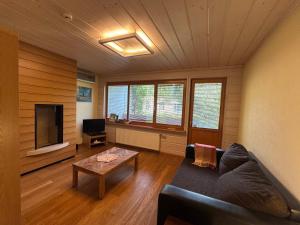 a living room with a couch and a coffee table at Melluzi Seaside Residence in Jūrmala