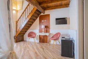 a living room with two chairs and a table at Salento Ada's House in Melendugno