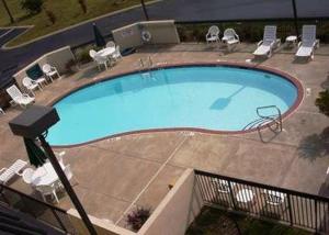 a large swimming pool with lounge chairs at Dyersburg Hotel in Dyersburg