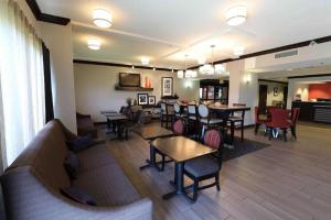 a lobby of a restaurant with tables and chairs at Dyersburg Hotel in Dyersburg