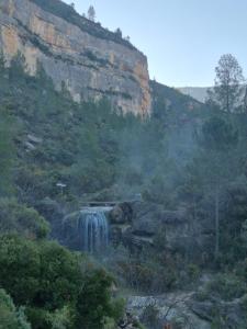a waterfall on the side of a mountain at Las Anas Rural in Cortez de Pallas