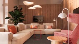 a living room with a couch and a table at Moov Hotel Matosinhos Sul in Matosinhos