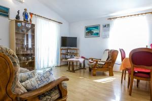 a living room with chairs and a tv at Holiday house Bruno in Savar