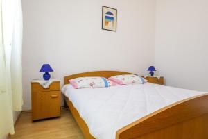 a bedroom with a bed with two pillows on it at Holiday house Bruno in Savar