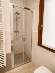 a shower with a glass door in a bathroom at residenza MINERVA & swimming pool in Aprilia Marittima