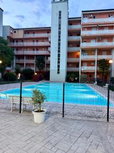a large swimming pool in front of a building at residenza MINERVA & swimming pool in Aprilia Marittima