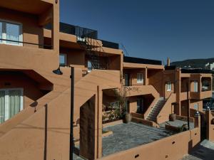a view of a building with stairs on it at Papi Boutique Hotel in Vathí