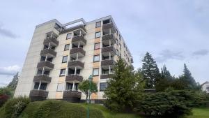 a tall building with balconies on the side of it at Apartment Am Paradies in Bad Lauterberg