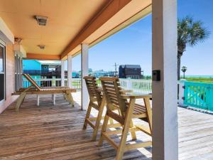 a porch with chairs and a table on a deck at Pelicans and Palms home in Crystal Beach +37 photos