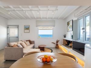 a living room with a table and a couch at myMykonos villa II in Platis Gialos