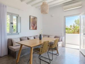 a dining room with a table and a couch at myMykonos villa II in Platis Gialos