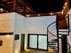 a spiral staircase in a building with windows at Casa Vibe PH- Private Rooftop - 3 Balcony - Pool in Tulum