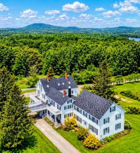 an aerial view of a large white house at Youngtown Inn in Youngtown