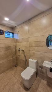 a bathroom with a toilet and a sink at Casa Luminaria in Alleppey