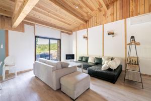 a living room with a couch and a chair at Le Mûrier - Grospierres in Grospierres
