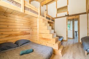 a room with two bunk beds and a staircase at Le Mûrier - Grospierres in Grospierres +21 photos