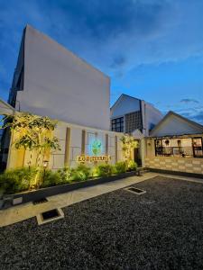 a building with a sign on the side of it at Lodjisvarga Villa Yogyakarta in Sleman