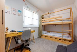a bedroom with a desk and bunk beds at Holiday Home Marija with pool in Buković +41 photos