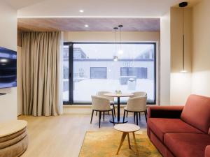 a living room with a couch and a table at Novotel Tallinn in Tallinn